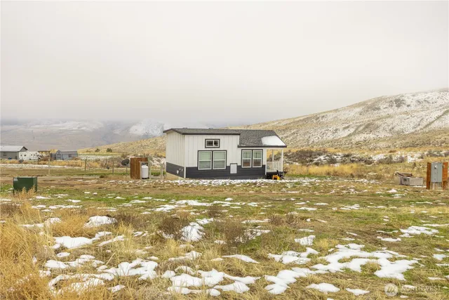 a view of a big room with an ocean and mountain view