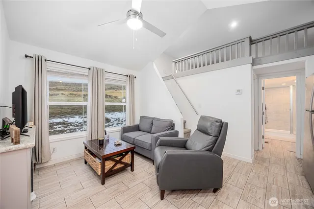 a living room with furniture and kitchen view
