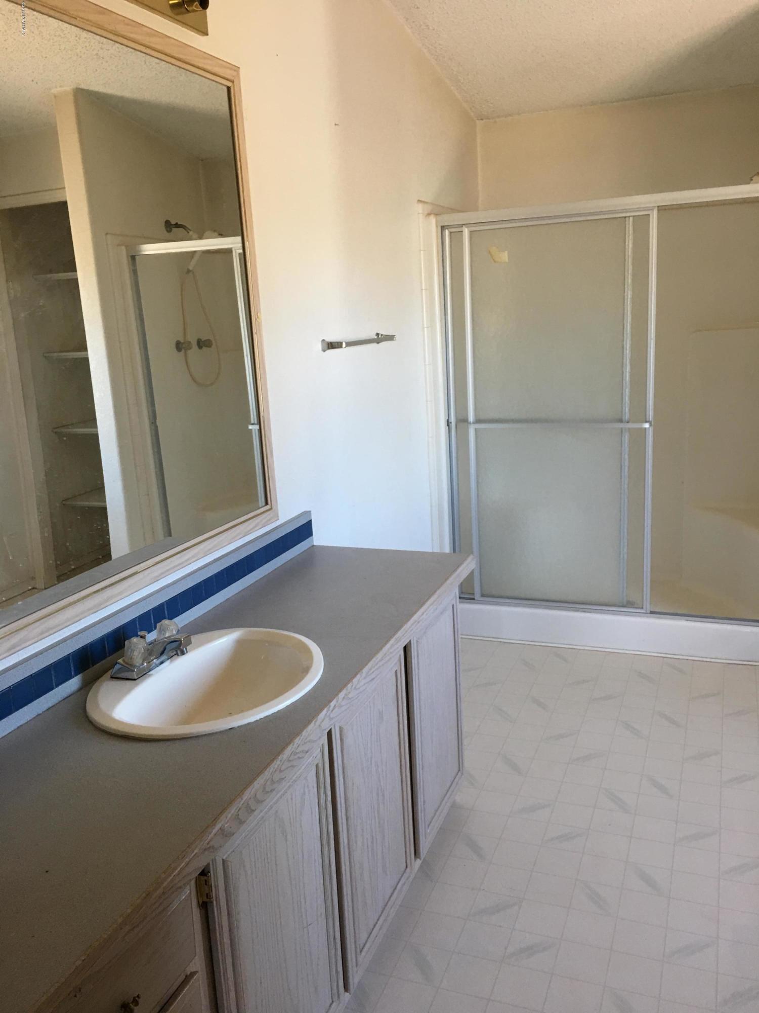 3467 Double A Ranch Road Williams, AZ 86046 - Photo 15 of 19 a bathroom with a sink vanity and a mirror