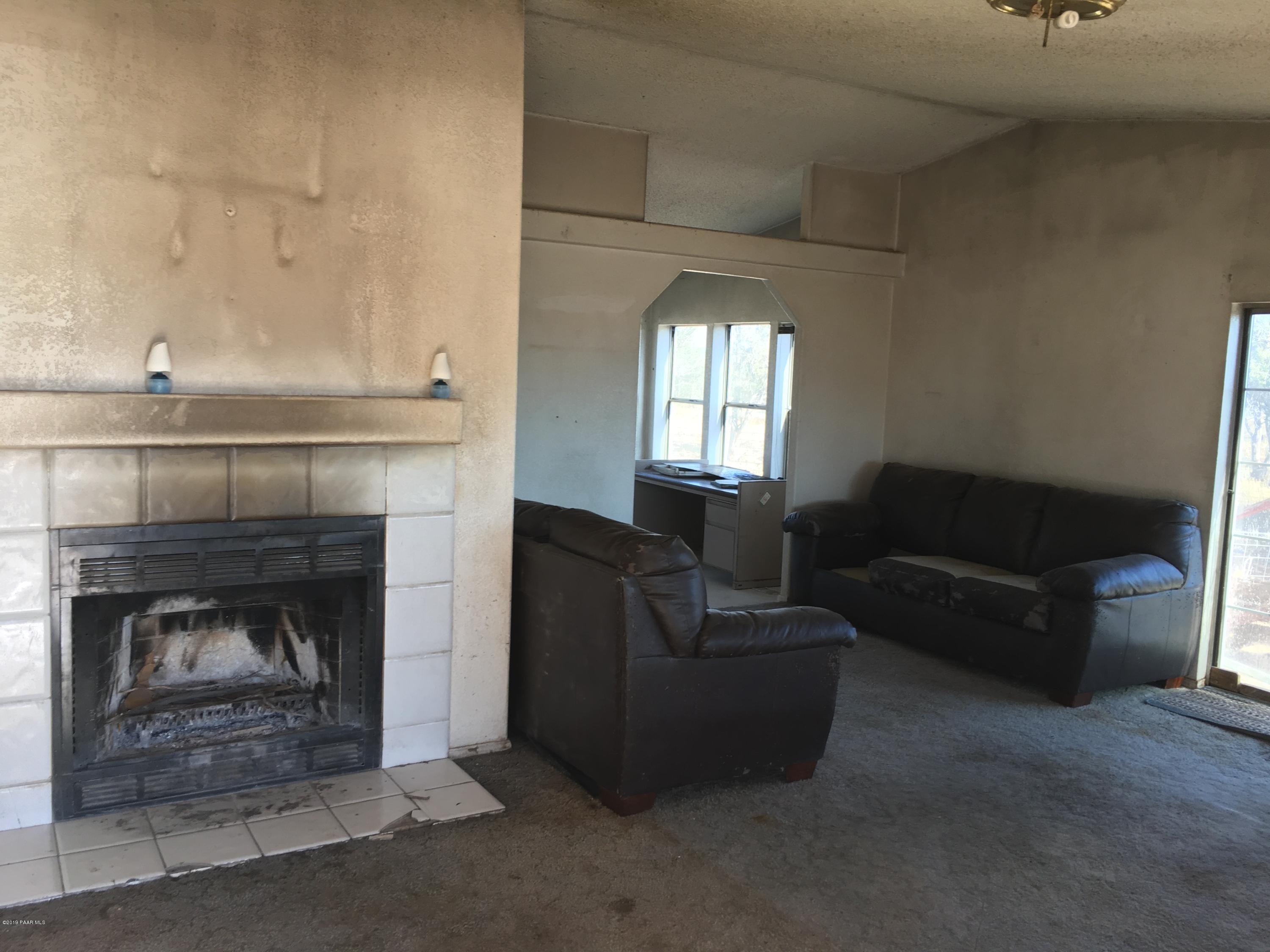 3467 Double A Ranch Road Williams, AZ 86046 - Photo 4 of 19 a living room with furniture and a fireplace