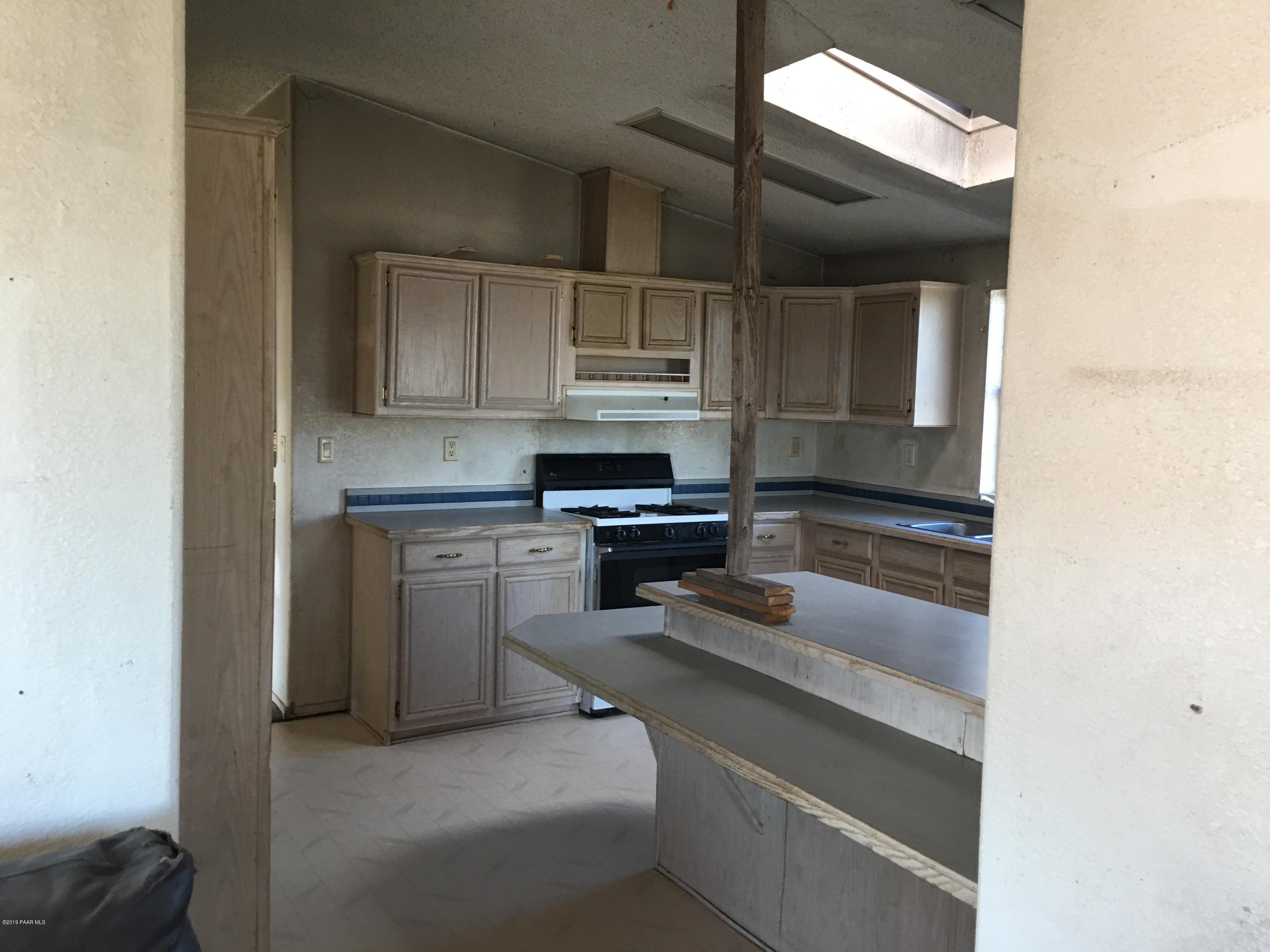 3467 Double A Ranch Road Williams, AZ 86046 - Photo 7 of 19 a kitchen with a refrigerator and a stove