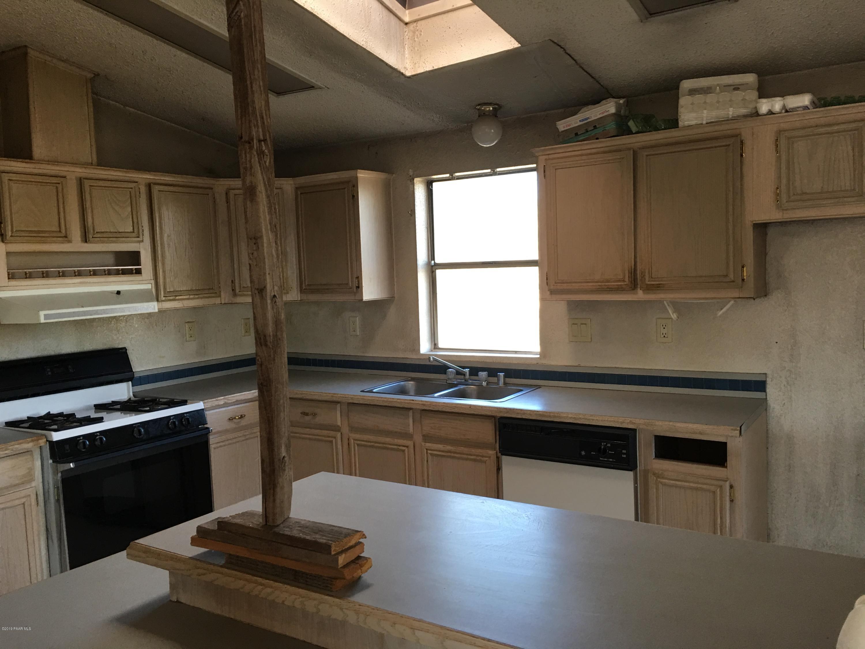 3467 Double A Ranch Road Williams, AZ 86046 - Photo 8 of 19 a kitchen with granite countertop a stove and a sink