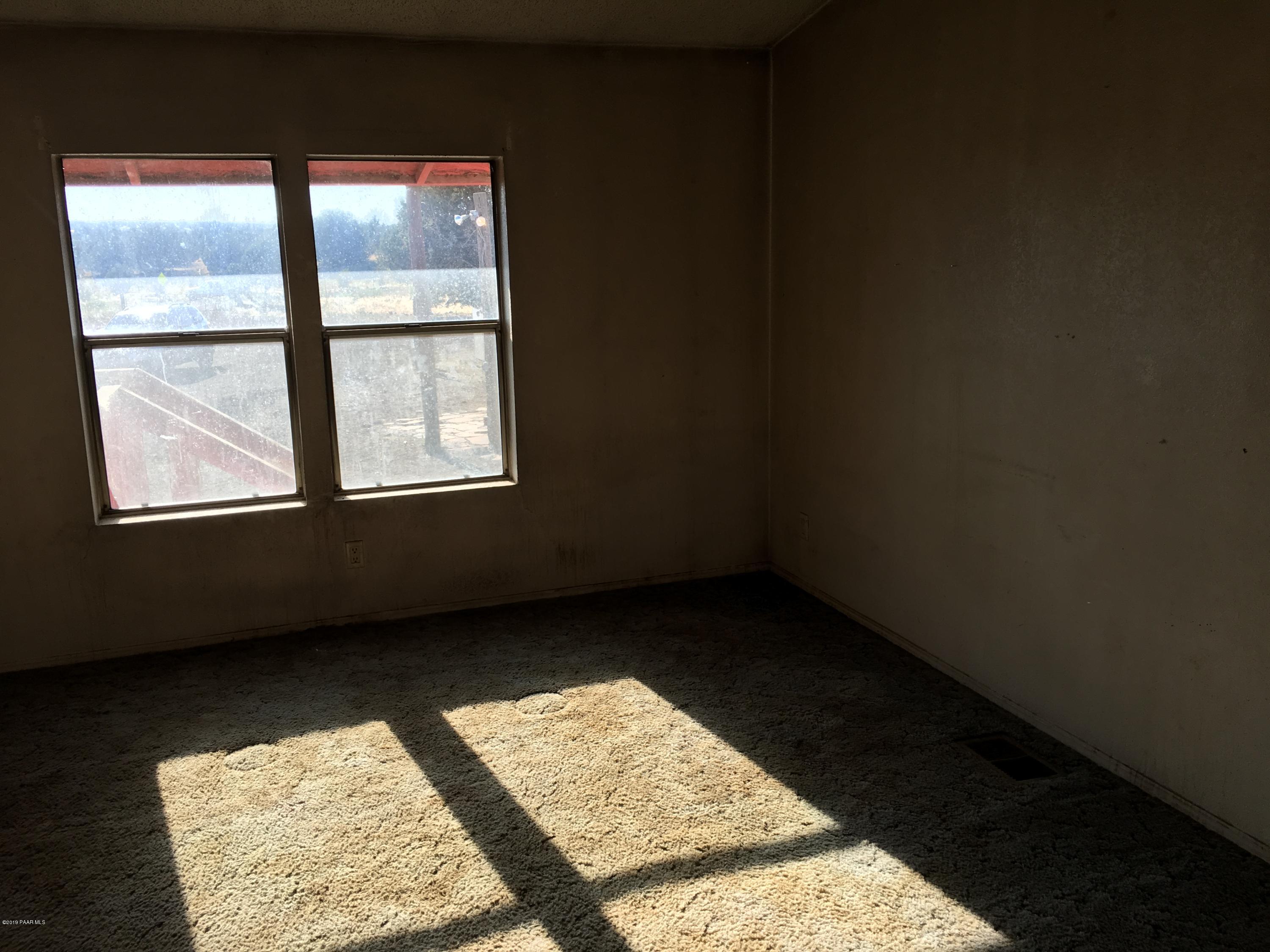 3467 Double A Ranch Road Williams, AZ 86046 - Photo 10 of 19 an empty room with wooden floor and windows