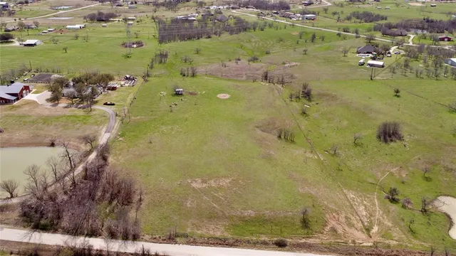 an aerial view of a residential houses with outdoor space
