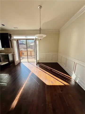 a room with wooden floor and ceiling fan