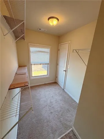 a view of an empty room with a fireplace