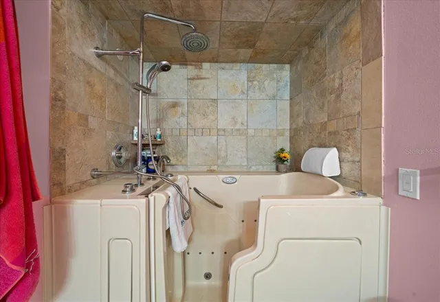 a living room with furniture a rug and a flat screen tv