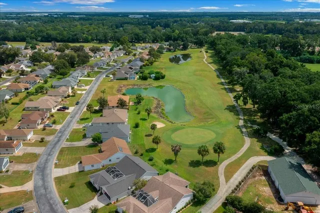 a view of house with swimming pool outdoor seating