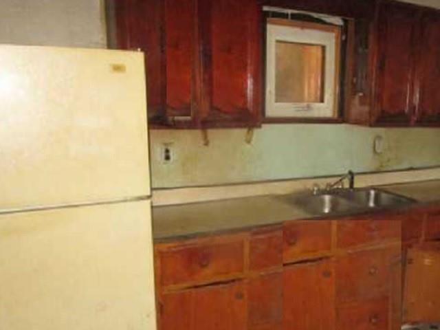 314 1/2 Lowell Street Vandergrift, PA 15690 - Photo 4 of 8 a bathroom with a sink and a refrigerator