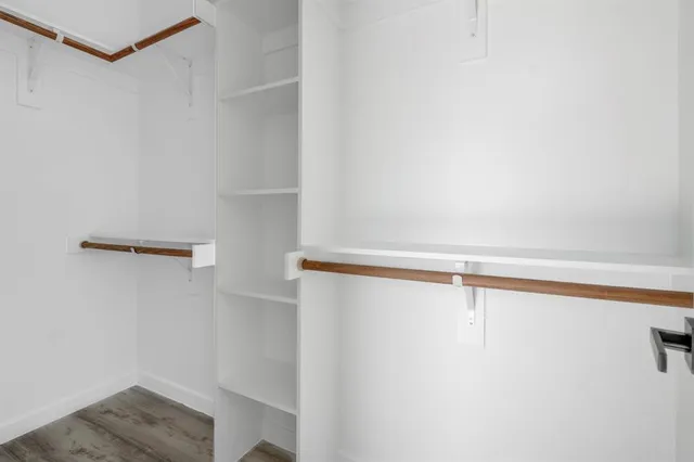 a view of walk in closet with empty racks