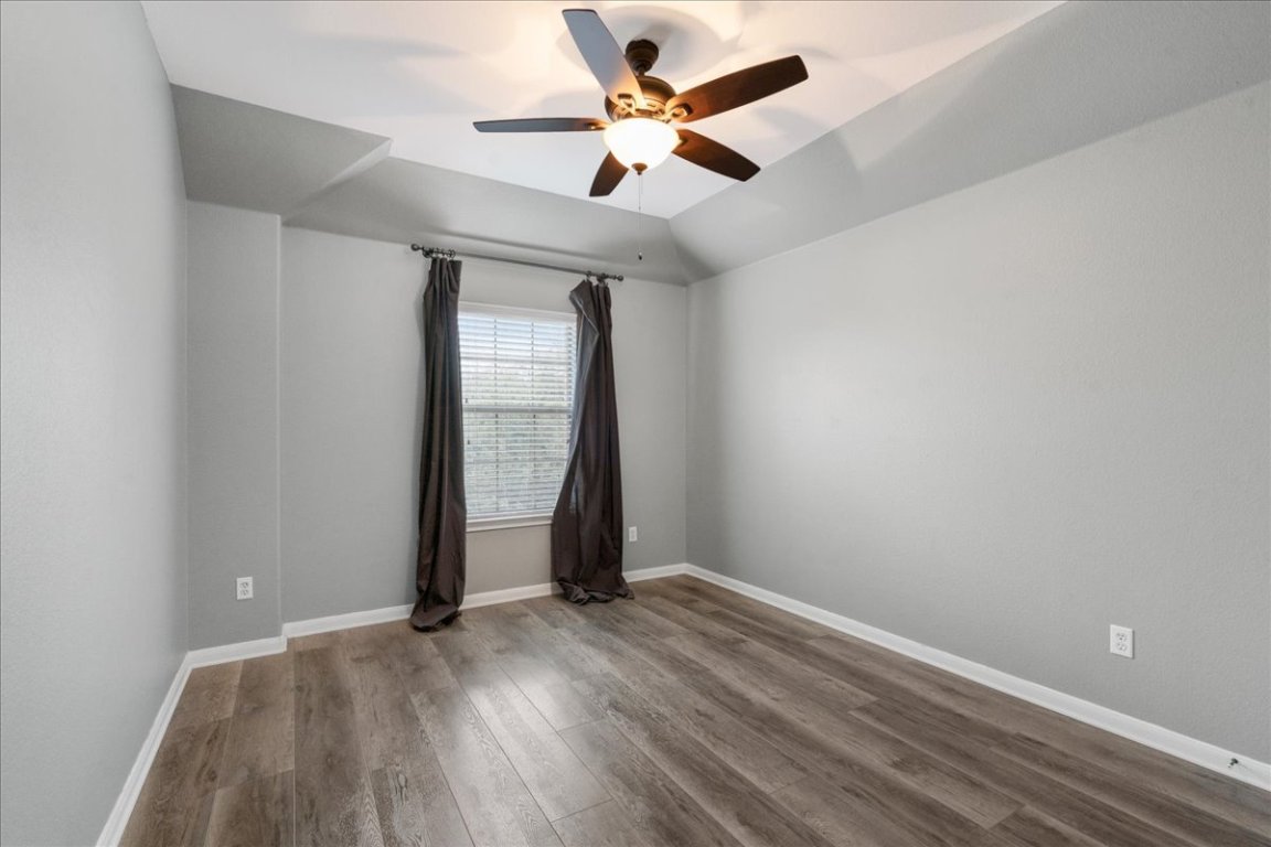 1813 Tall Chief Leander, TX 78641 - Photo 22 of 26 Unfurnished room featuring baseboards, a ceiling fan, and wood finished floors