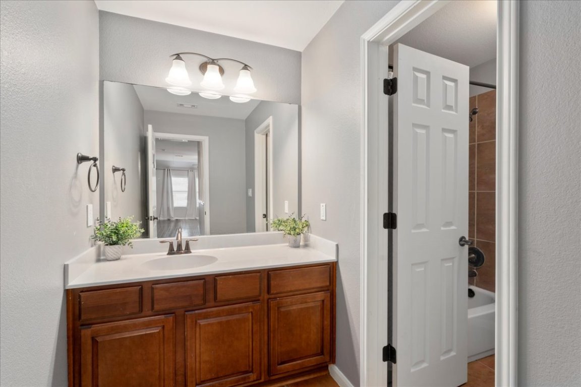 1813 Tall Chief Leander, TX 78641 - Photo 23 of 26 Bathroom featuring vanity, shower / bathtub combination, and visible vents