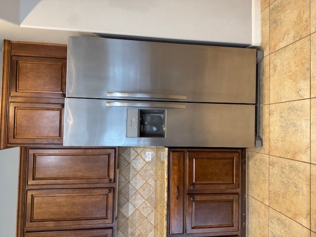 1813 Tall Chief Leander, TX 78641 - Photo 26 of 26 Kitchen with stainless steel fridge with ice dispenser, backsplash, light stone countertops, and light tile patterned floors