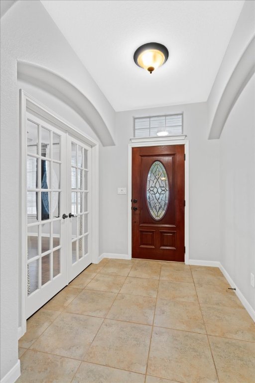 1813 Tall Chief Leander, TX 78641 - Photo 7 of 26 Entryway with baseboards, french doors, and tile patterned flooring
