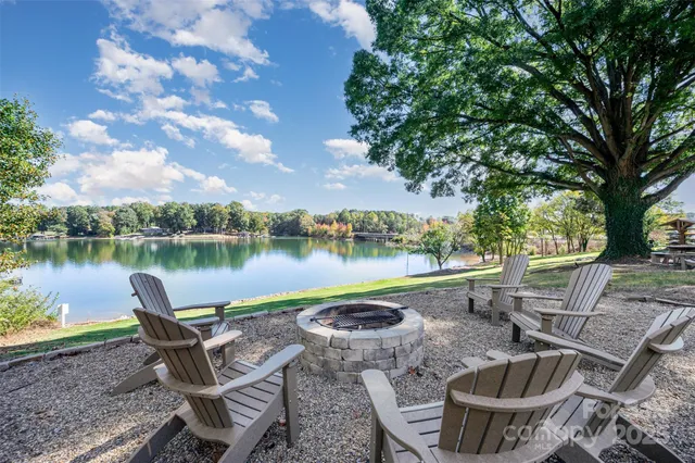 a view of a lake with couches chairs and a lake view