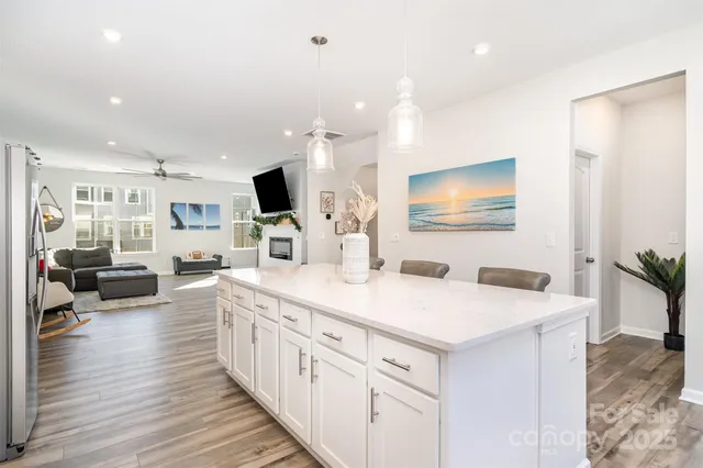 a kitchen with sink stove and refrigerator