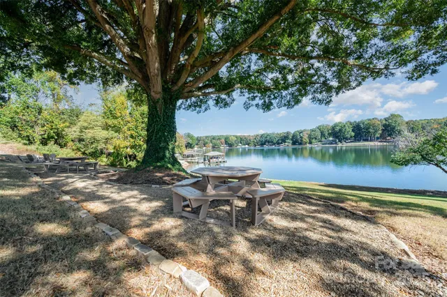 a view of a house with pool and chairs