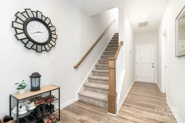 a view of a room with wooden floor and white walls