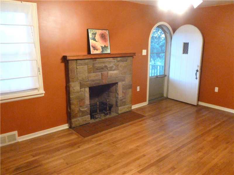 543 Ridge Road Ambridge, PA 15003 - Photo 10 of 23 Living Room. Comfortable and spacious - Living room with gas fireplace. Also - Original ,cute rounded-top front door. This house has character!