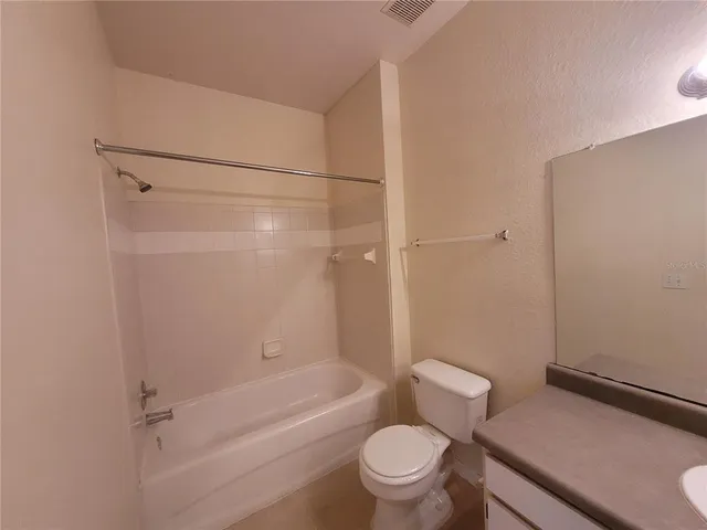 a bathroom with a toilet and a bath tub
