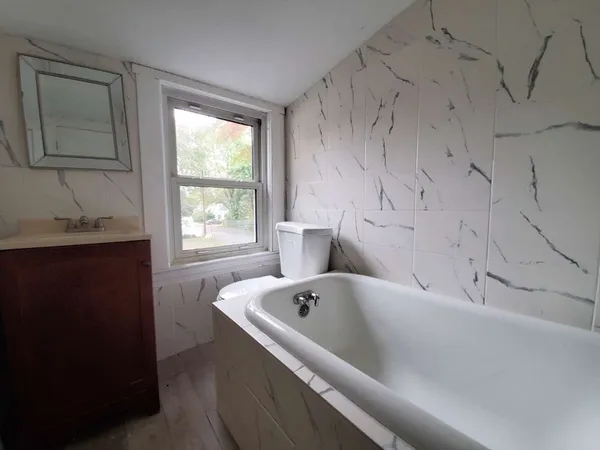 a white toilet sitting next to a bathroom sink