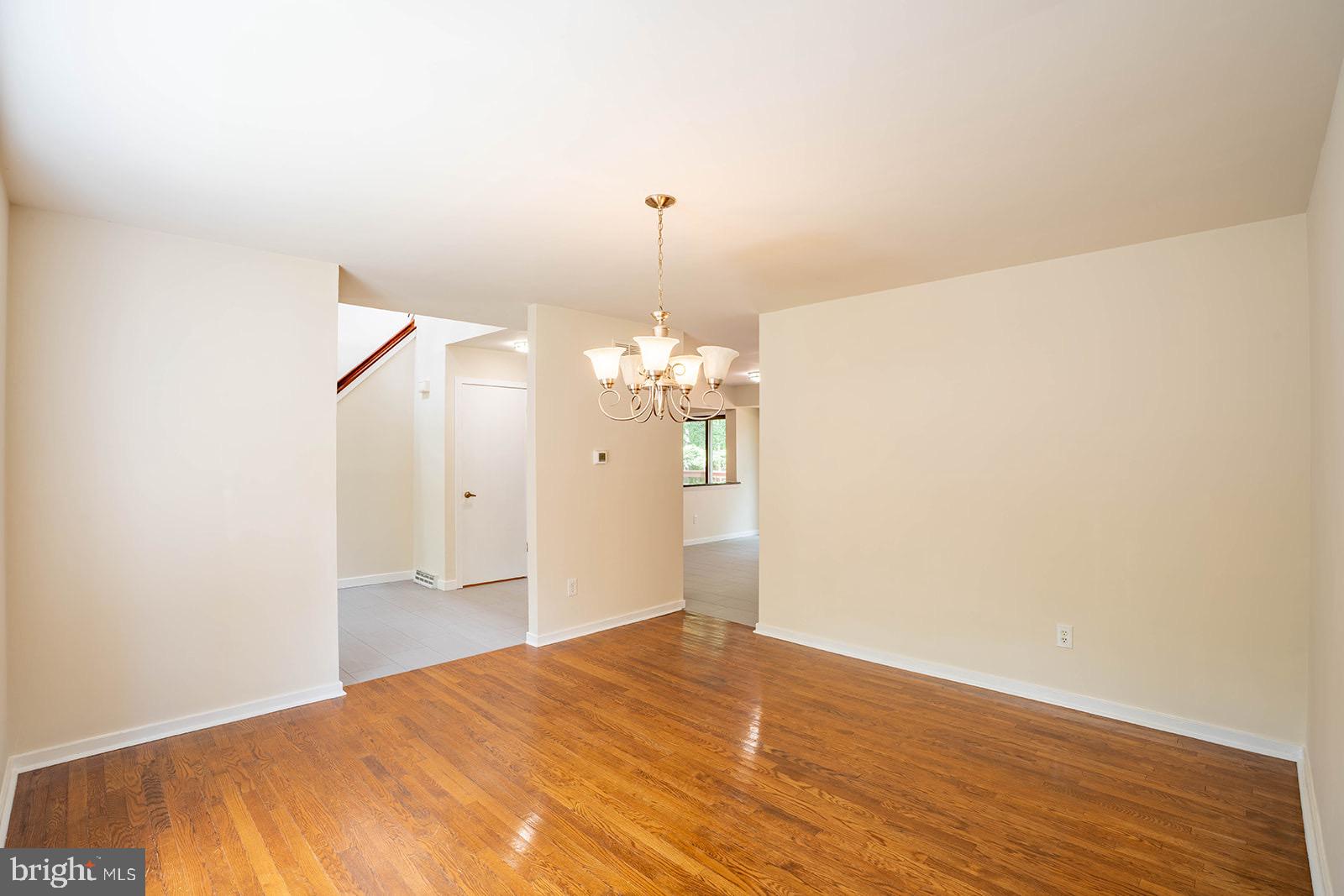 491 Kings Road Yardley, PA 19067 - Photo 13 of 52 a view of a room with wooden floor and chandelier