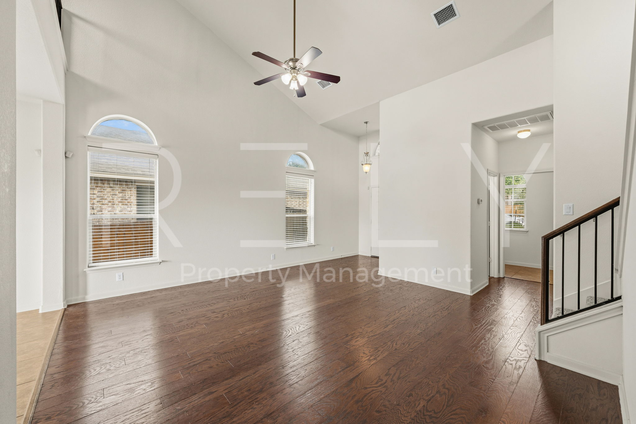 1405 Sunny Meadows Loop Georgetown, TX 78626 - Photo 5 of 40 Hardwood floors and a vaulted ceiling elevate this spacious, naturally illuminated living area.
