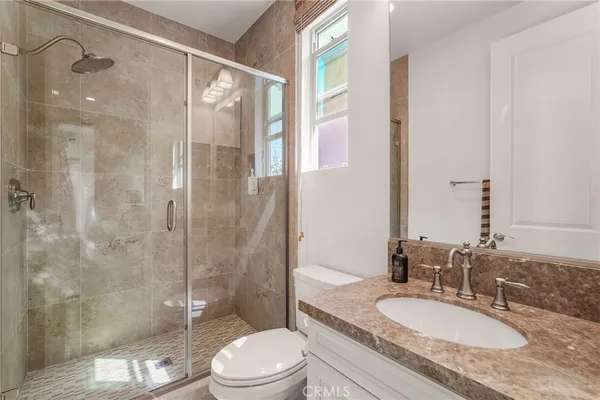 a bathroom with a sink toilet and shower