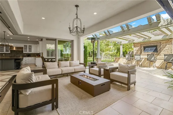 a view of a patio with table and chairs next to a yard
