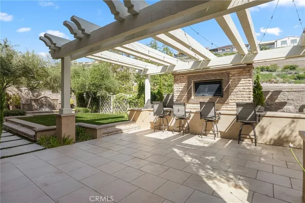 a view of a house with backyard sitting area and garden