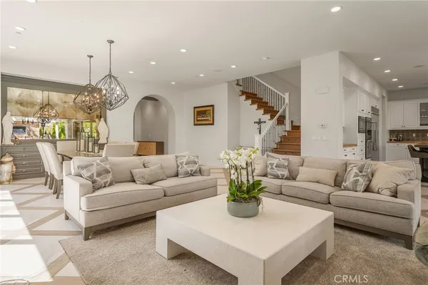 a kitchen with stainless steel appliances granite countertop a stove a sink dishwasher a refrigerator and cabinets with wooden floor