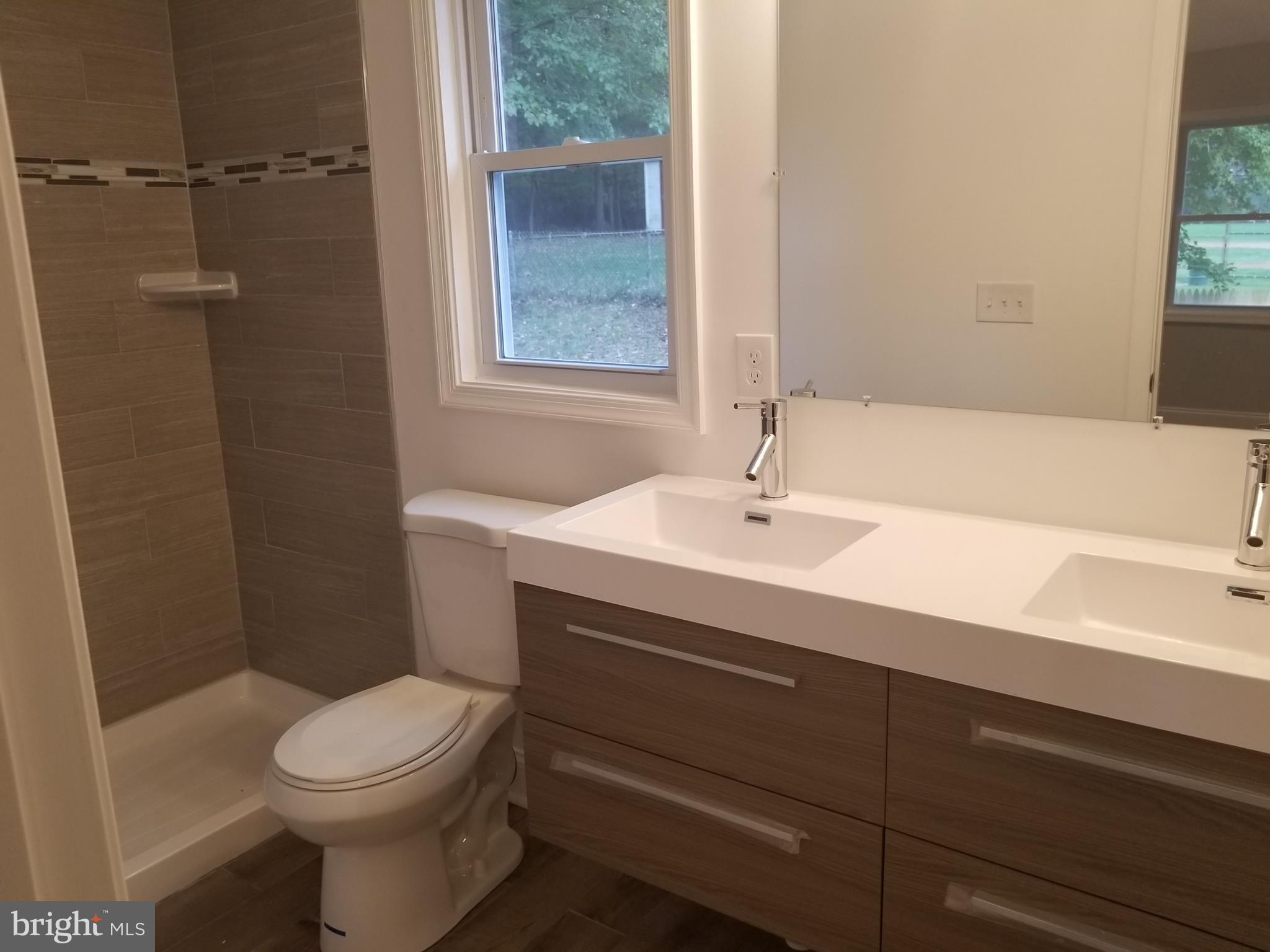 6828 Campfield Road Baltimore, MD 21207 - Photo 14 of 26 a bathroom with a sink toilet and shower