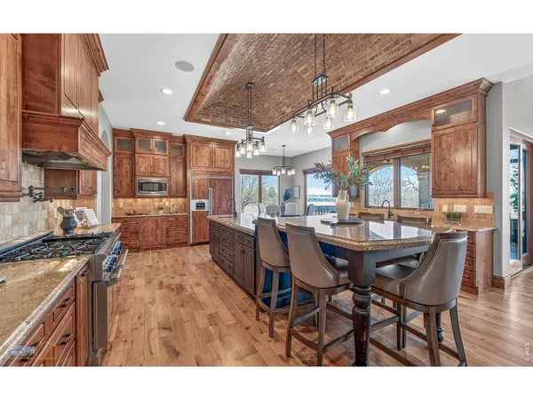 a living room with furniture a fireplace and a large window