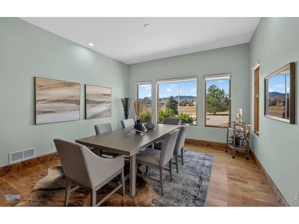 a living room with stainless steel appliances kitchen island granite countertop a refrigerator a sink a oven a dining table and chairs