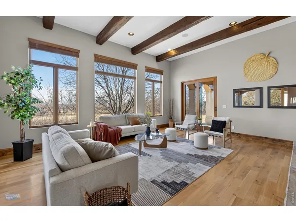 a spacious bedroom with a bed a couch and a large window