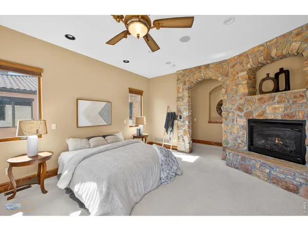 a living room with furniture a flat screen tv and a large window