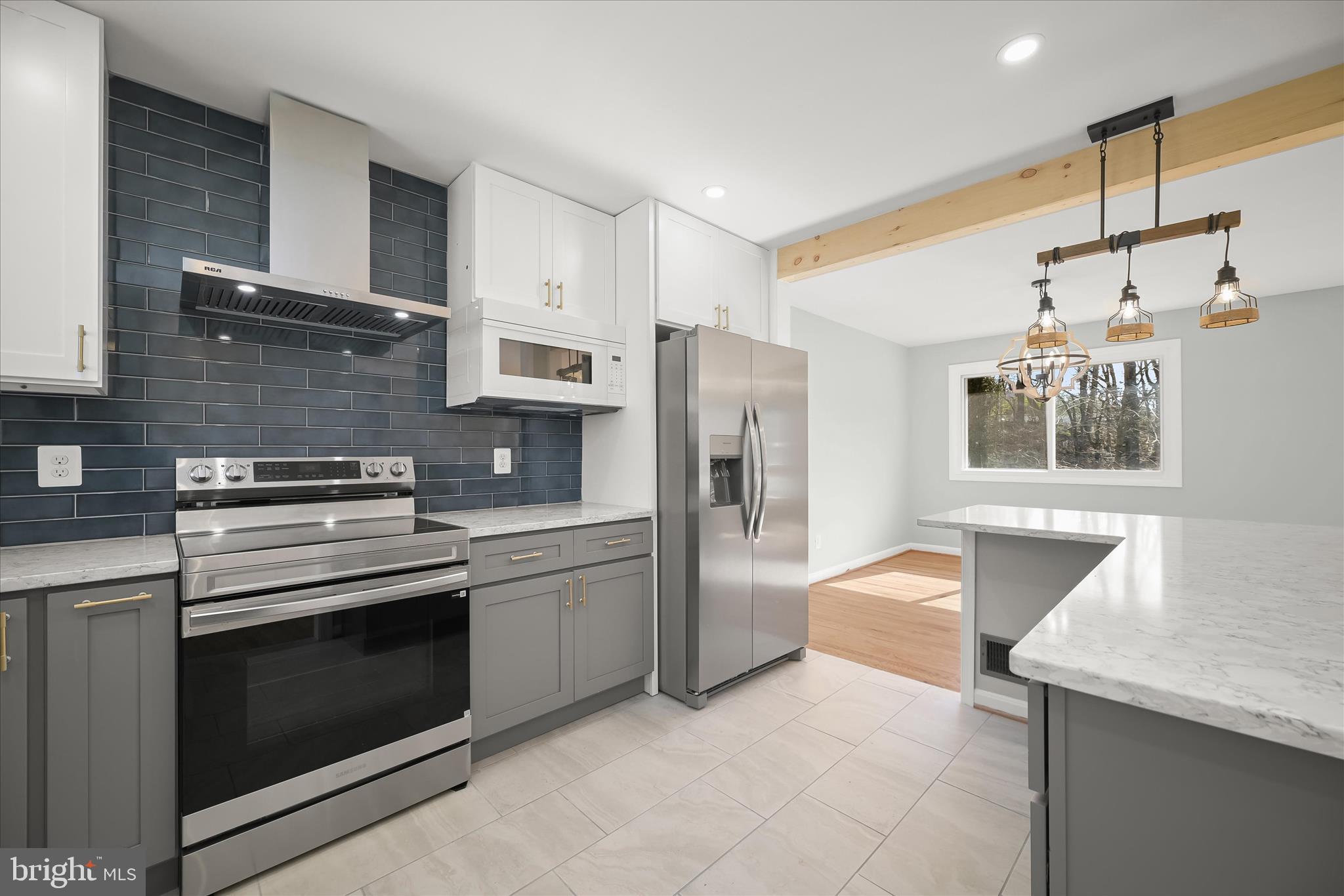 9720 Hedin Drive Silver Spring, MD 20903 - Photo 22 of 79 a kitchen with stainless steel appliances granite countertop a stove and a refrigerator