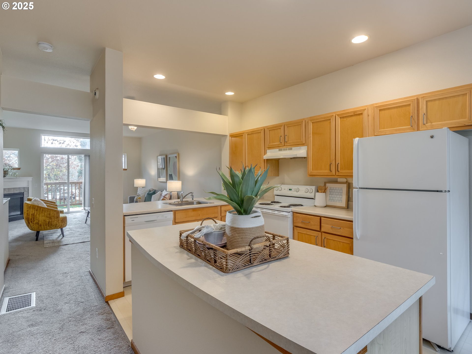 606 Southwest Dillan Drive Beaverton, OR 97006 - Photo 11 of 29 a kitchen with a refrigerator a stove and white cabinets