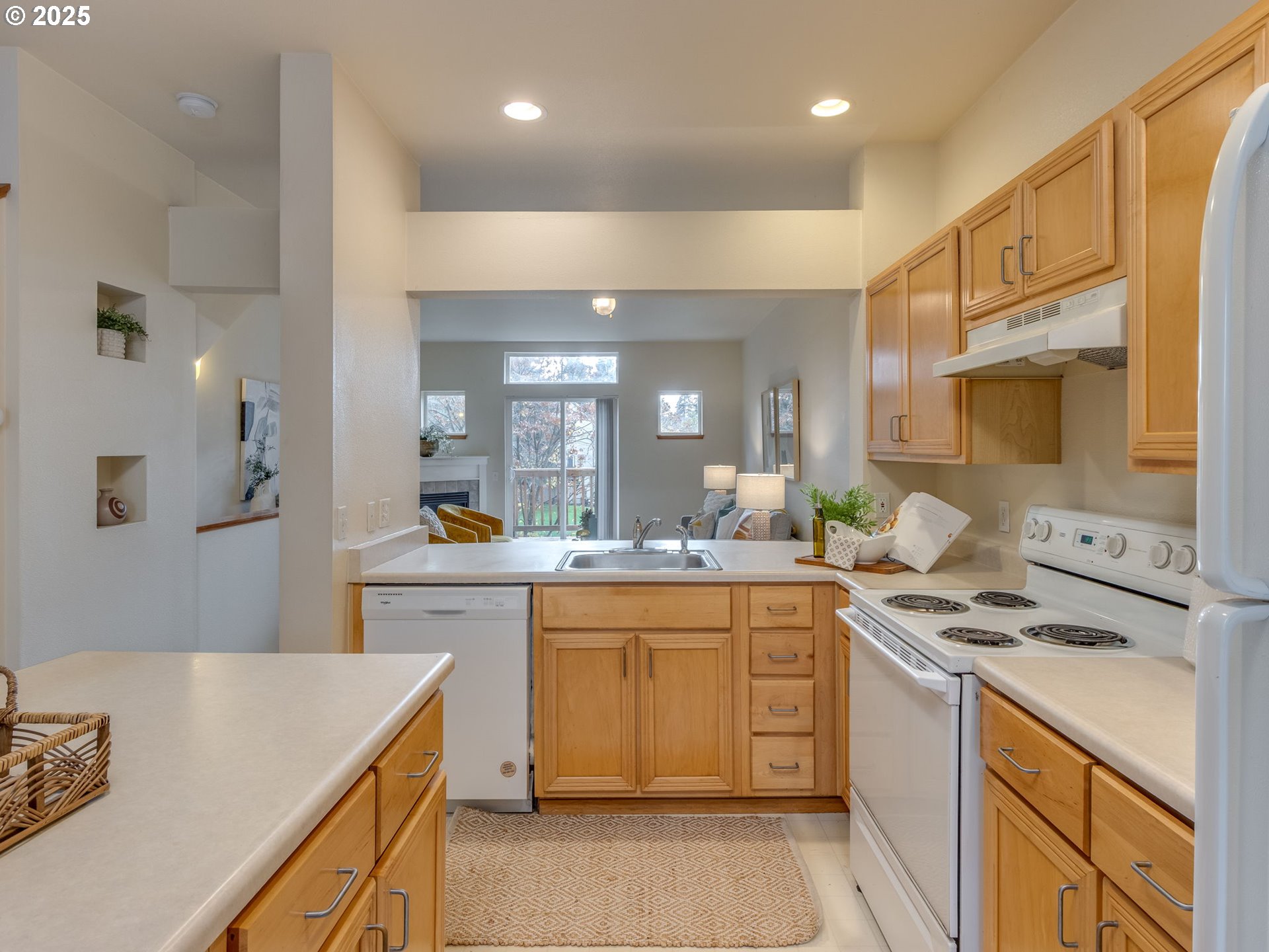 606 Southwest Dillan Drive Beaverton, OR 97006 - Photo 12 of 29 a kitchen with a sink a stove and cabinets