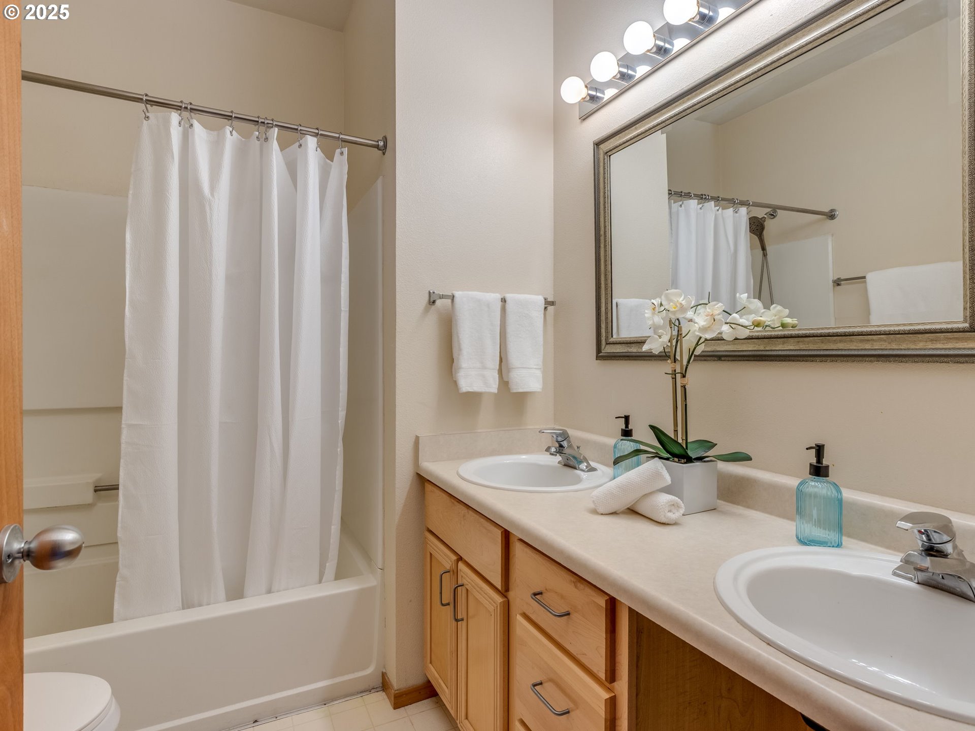 606 Southwest Dillan Drive Beaverton, OR 97006 - Photo 22 of 29 a bathroom with a double vanity sink and a mirror