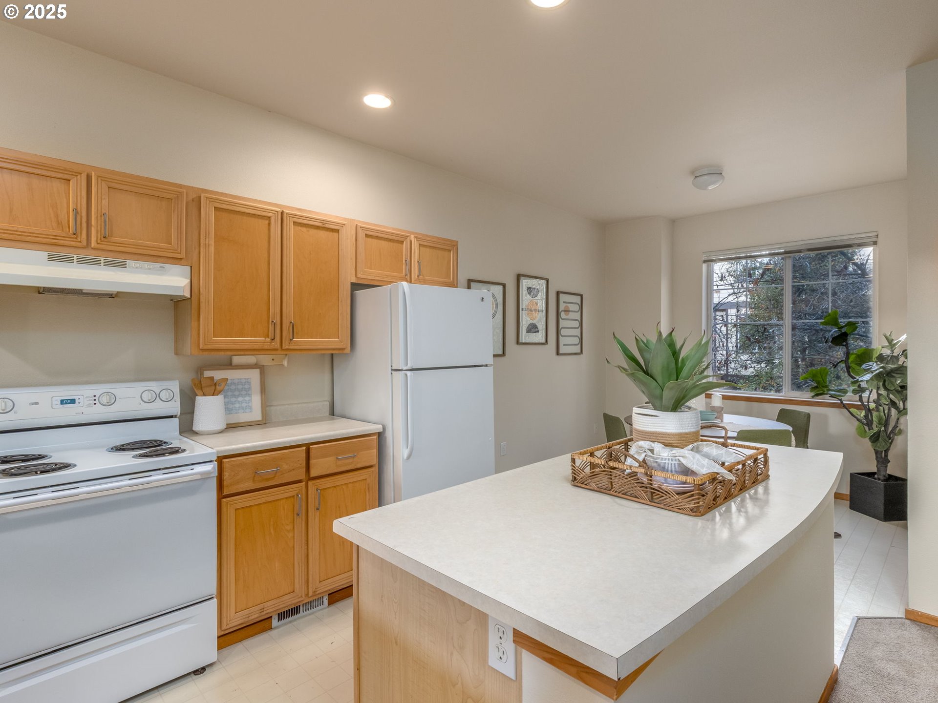 606 Southwest Dillan Drive Beaverton, OR 97006 - Photo 10 of 29 a kitchen with a stove a refrigerator and a white cabinets