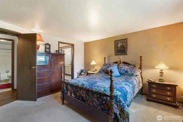 a bedroom with a bed and a flat screen tv in it