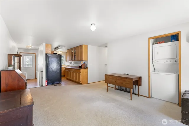 a spacious bedroom with a bed and a dresser next to a window