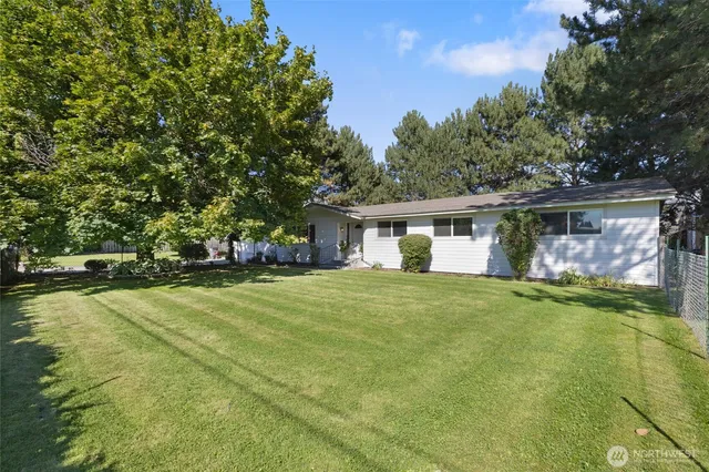 a front view of house with yard and trees