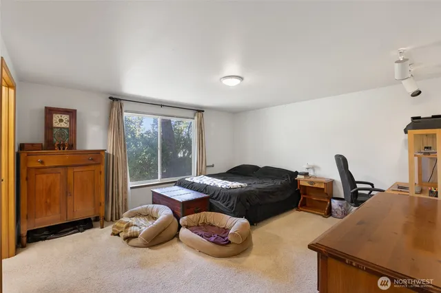 a bedroom with furniture and a window