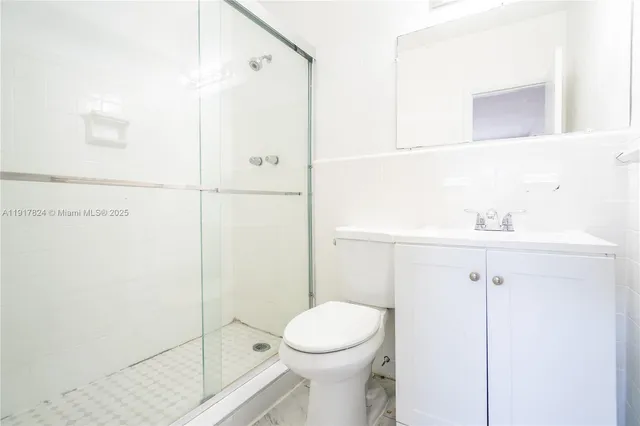 a bathroom with a toilet a sink and shower