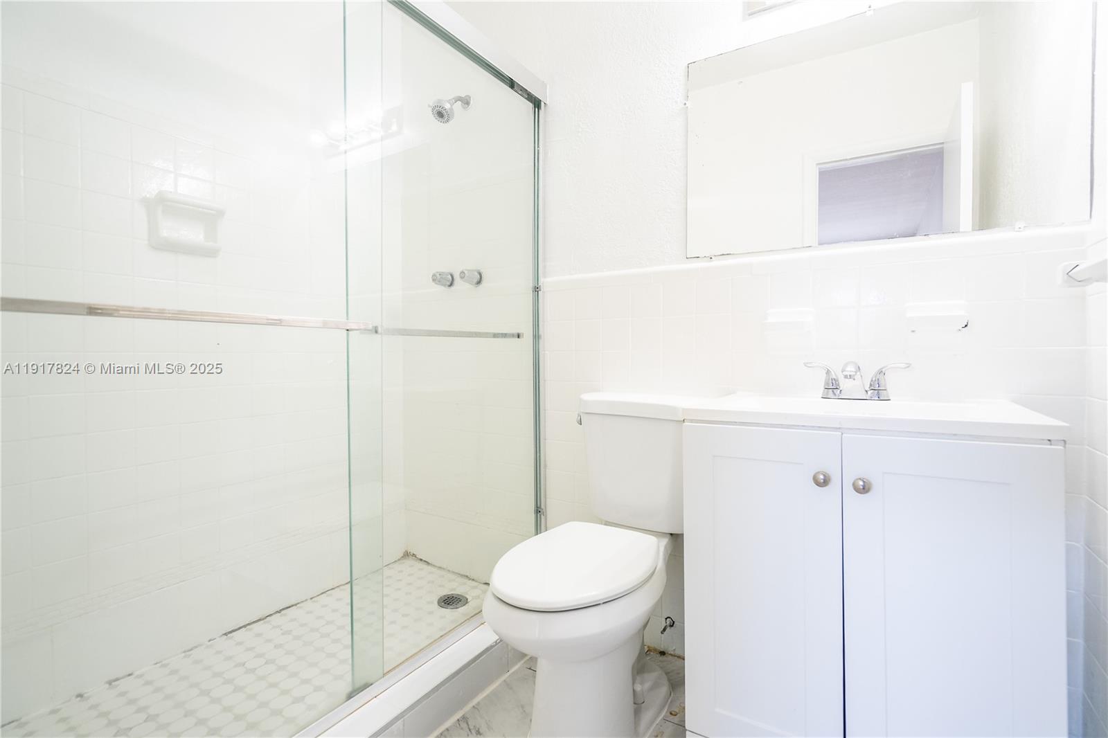330 84th Street, Unit 12 Miami Beach, FL 33141 - Photo 13 of 20 a bathroom with a toilet a sink and shower