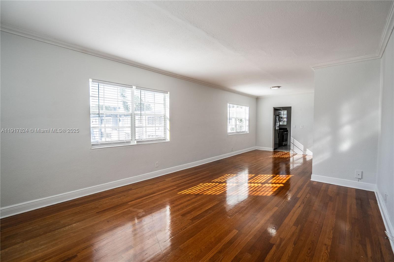 330 84th Street, Unit 12 Miami Beach, FL 33141 - Photo 2 of 20 a view of empty room with wooden floor and fan