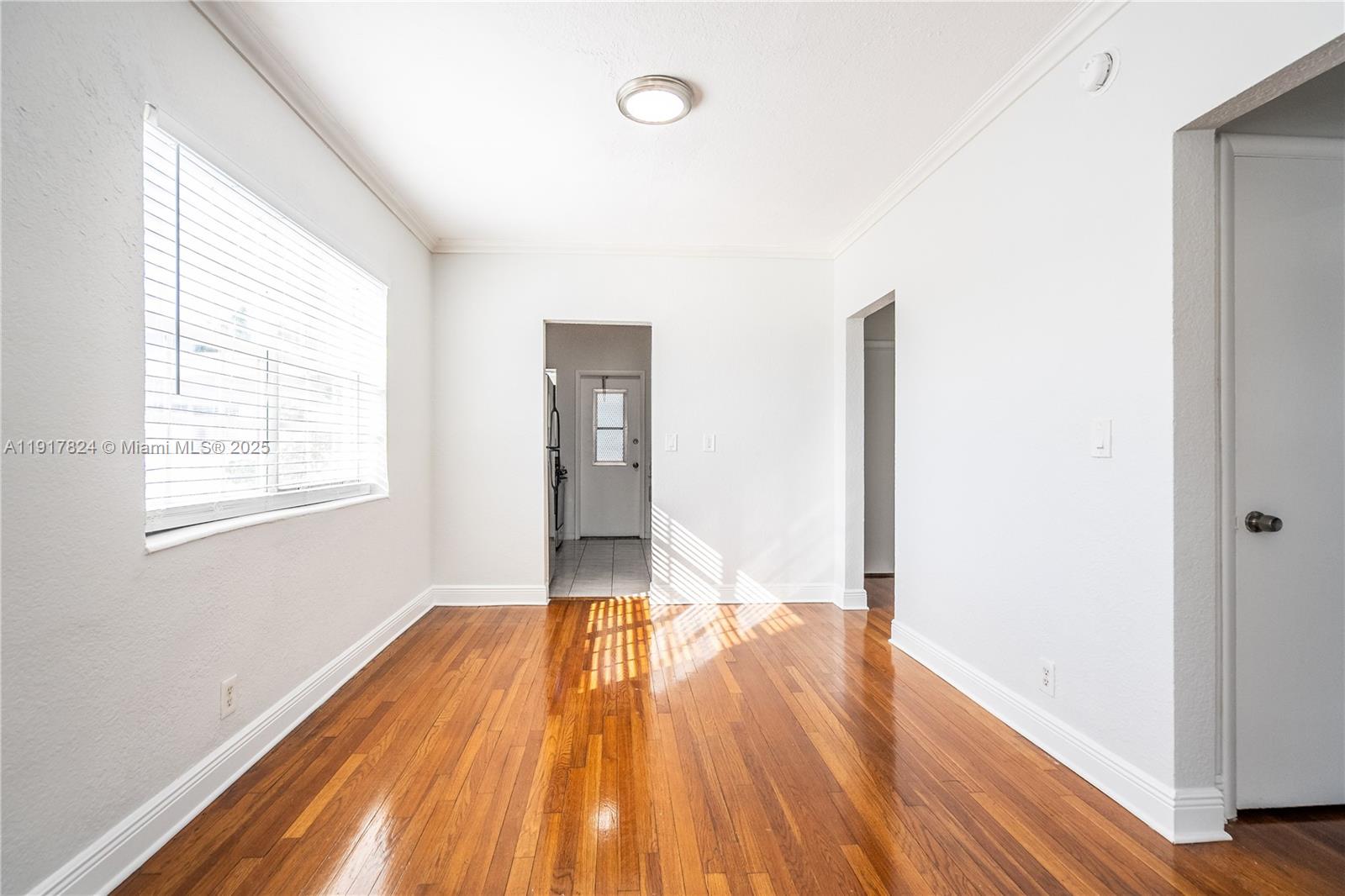330 84th Street, Unit 12 Miami Beach, FL 33141 - Photo 6 of 20 a view of empty room with wooden floor and fan