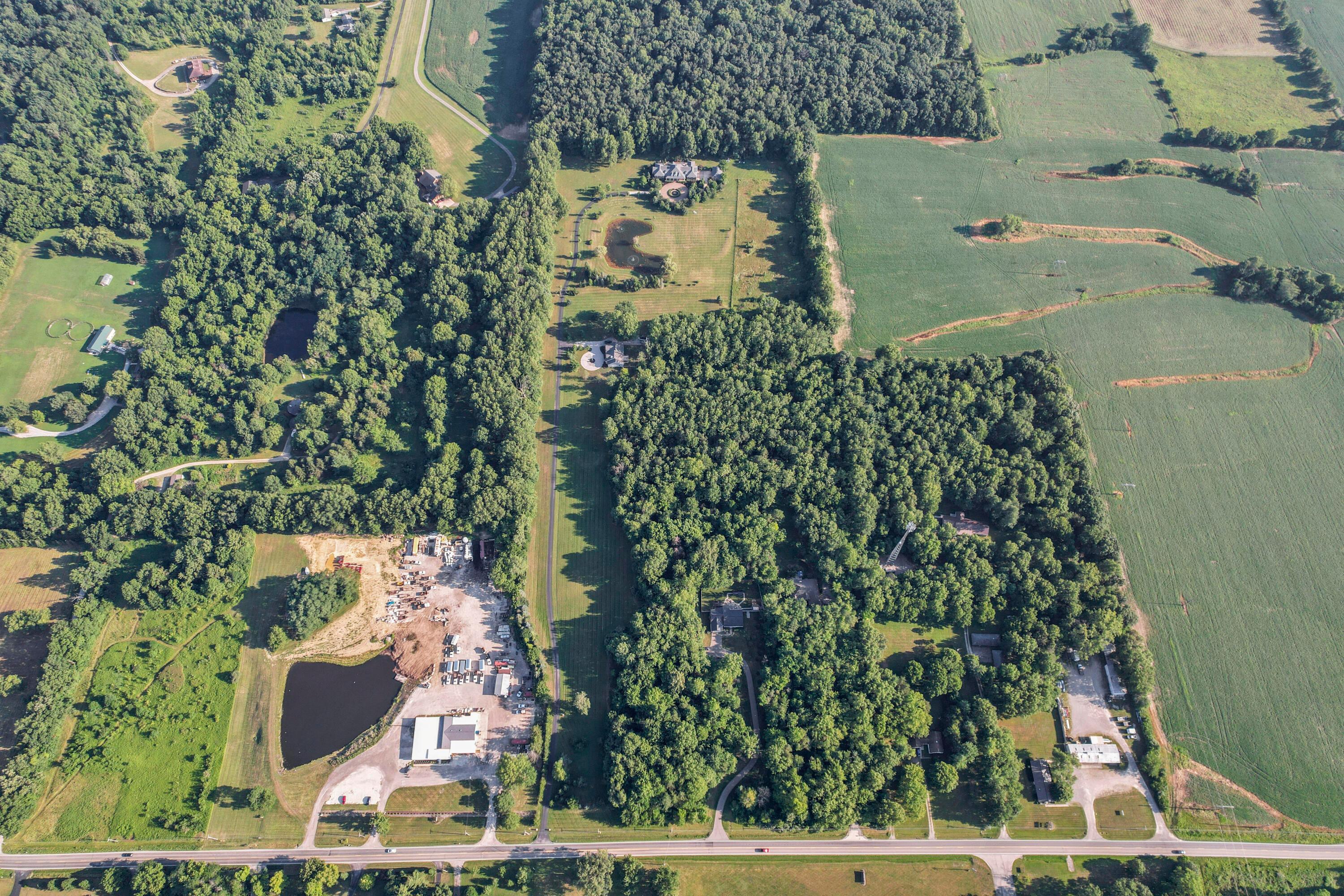 3575 State Rte 37 West Delaware, OH 43015 - Photo 20 of 106 Aerial perspective showcasing expansive green spaces, including wooded areas and cultivated fields